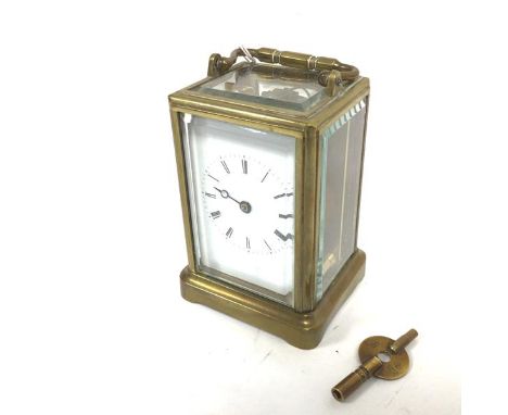 An Edwardian caddy style cased four glass carriage clock with glazed panel sides and top, enamel dial and roman numerals, mis