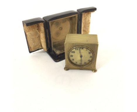 A Zenith Swiss made alarm clock with engine turned brass case and gilt dial with arabic numerals, retailed by James Ritchie &