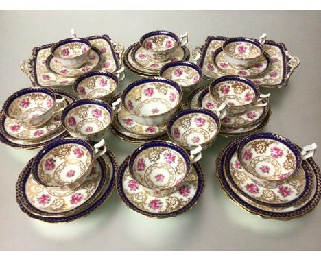 A Cauldon china thirty eight piece tea service including sugar basin, two cake plates, teacup, saucers and side plates, all d