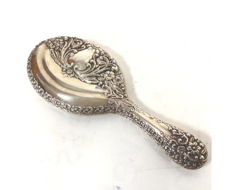 A Walker &amp; Hall chased silver backed dressing table hand mirror with rose, leaf and scrolling border (26cm x 10cm)