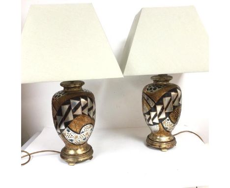 A pair of Art Deco inspired baluster vase ceramic table lamps, raised on gilded and silvered hardwood stands, complete with s