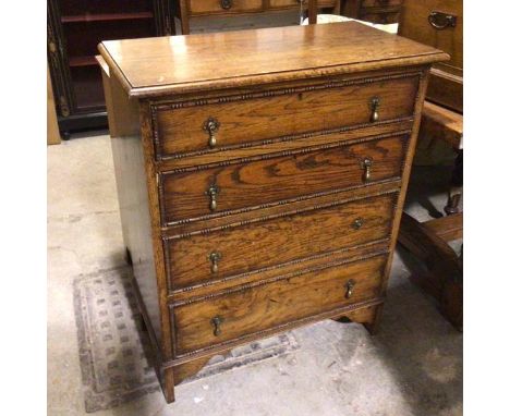 A 1920s oak chest, the rectangular top above four graduated long drawers, with beaded borders, on bracket style feet (93cm x 