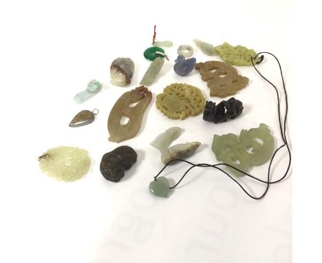 A collection of modern jadeite carved pendants including two archaic style pendants, a dyed green jade circular pendant, a gr