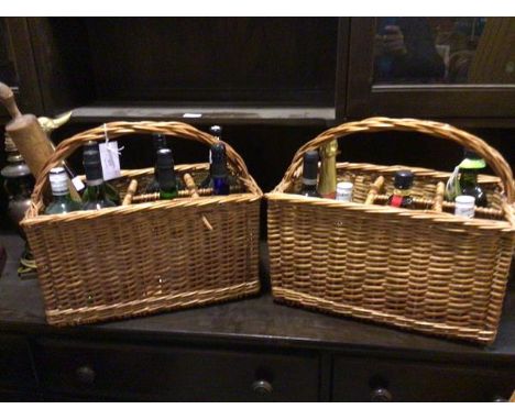 Two wicker spirit baskets complete with various spirits etc. (39cm x 43cm x 23cm), a walking stick top and a rolling pin