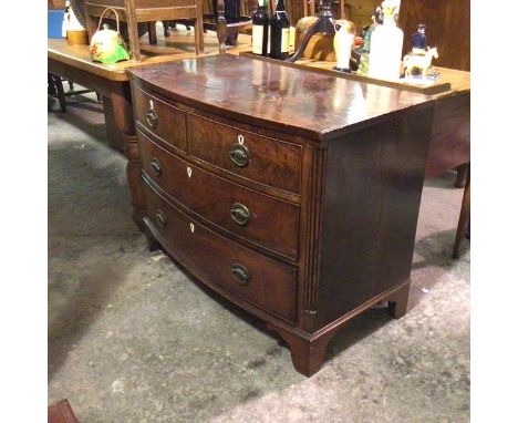 A 19thc mahogany bow front chest, fitted two short and two long drawers, with oval plaque handles and fluted pilasters to sid