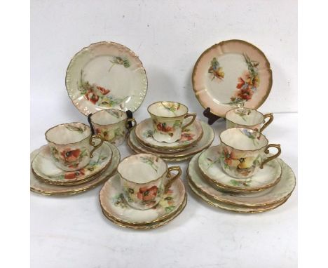 A Nautilus porcelain twenty two piece tea service decorated with traditional red and yellow poppy design, with scalloped gilt