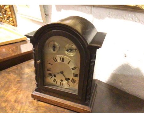 A late 19thc/early 20thc oak cased eight day German bracket clock, with silvered dial and Westminster chime movement, with tw