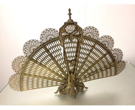 A cast brass Edwardian style peacock fan firescreen raised on cast acanthus leaf base (61cm x 85cm fully extended)