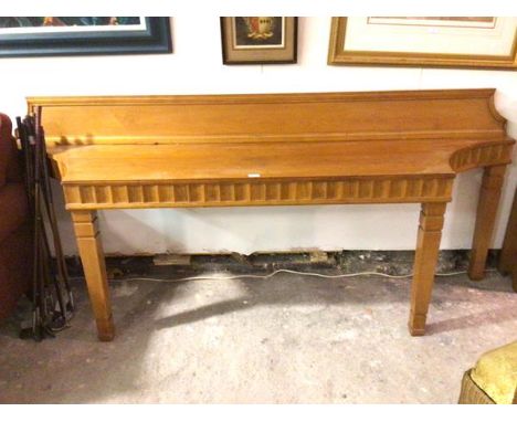 A modern custom made yew wood console table of eliptical sided form with fluted frieze and ledge back, on square moulded supp