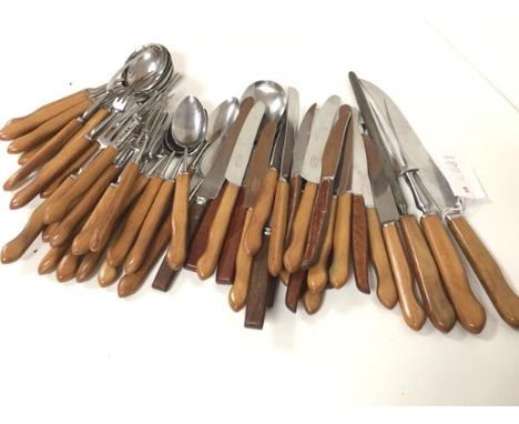 A collection of 1960s/70s teak handled stainless steel flatware including soup spoons, dessert spoons, three pronged forks, t