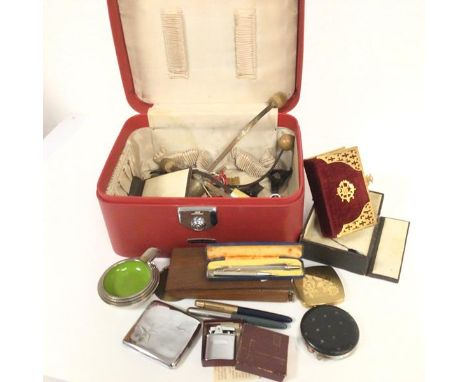 A vanity case containing The Common Prayer book, two silver propelling pencils, a Ronson lighter, a set of weights and opium 