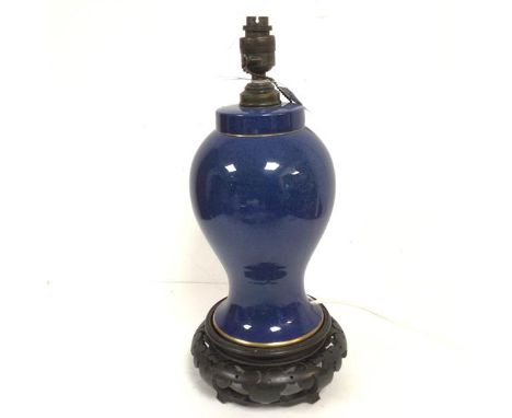 A baluster lamp with hardwood associated stand, with lapis style blue glazed decoration and gilt borders (including stand: 38