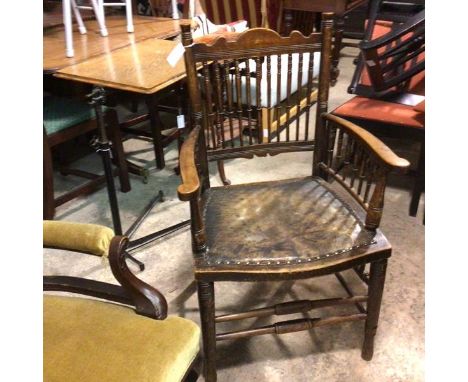 An Edwardian stained beech Arts &amp; Crafts style spindle back chair with inset leather seat, on ring turned tapered support