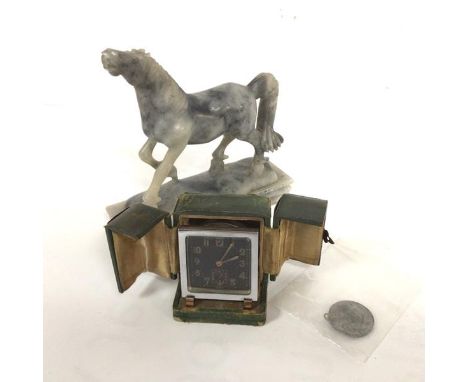 An chromium plated 1930s alarm clock with black luminous dial, complete with travelling case, missing seconds hand, a commemo