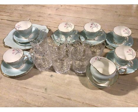 A group of seven crystal slice cut tumblers, a Paragon china twenty piece tea service decorated with pale blue and floral spr