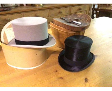 A leather hat box containing a gentleman's M.D. Dunlop &amp; Co., Edinburgh silk top hat (inside front to back: 21cm x 17cm) 