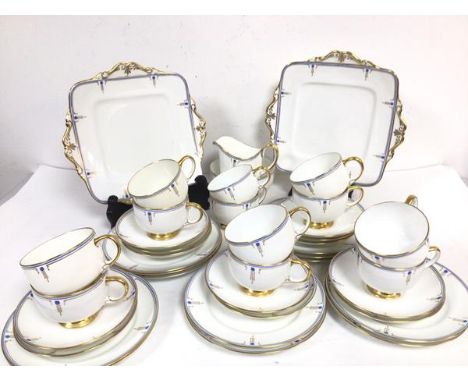 A Paragon china Art Deco inspired forty piece tea service with stylised flower, gold and blue bordered design complete with t