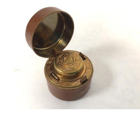 A leather covered brass inset travelling inkwell (4.5cm x 5cm)