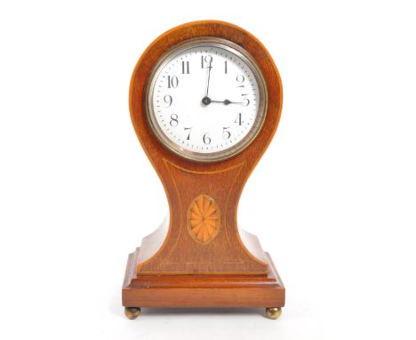 An Edwardian walnut inlaid balloon shaped mantel clock with shell design inlay. Raised on rectangular stepped base supported 