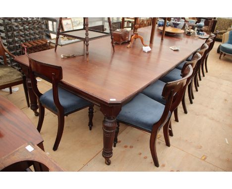 A VICTORIAN MAHOGANY EXTENDING DINING TABLE with turned tapering legs terminating in ceramic castors, three extra leaves and 