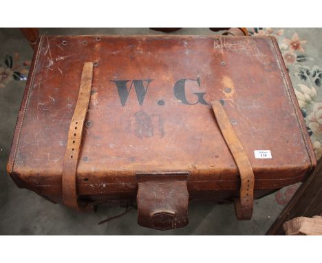 A LATE 19TH CENTURY LEATHER TRAVELLING TRUNK by Jones of Leamington Spa, 69cm wide together with a quantity of antique overco
