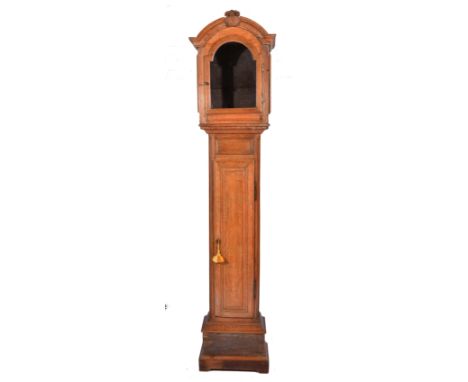 A CONTINENTAL OAK LONG CASE CLOCK CASE, the hood with arched pediment and a central basket of flowers, trunk with a single pa