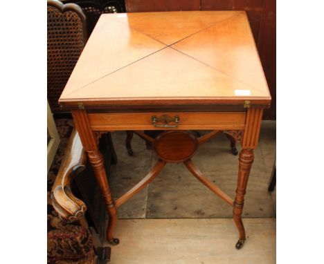 A VICTORIAN MAHOGANY WALNUT ENVELOPE CARD TABLE with single frieze drawer, turned fluted tapering legs united by an 'X' stret