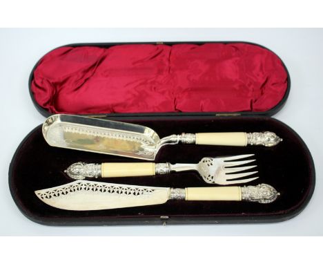 A VICTORIAN CASE SILVER MOUNTED IVORY HANDLED SERVING KNIFE AND FORK with pierced decoration together with a matching crumb s