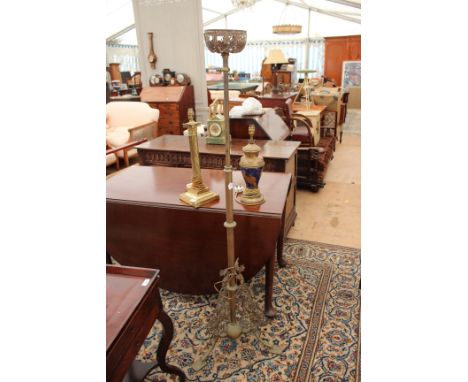 A VICTORIAN BRASS ADJUSTABLE LAMP STANDARD with pierced tripod base together with a brass table lamp of Corinthian column for