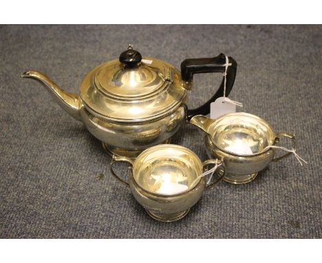 A 20TH CENTURY SILVER THREE PIECE TEASET the teapot engraved A & H.D. 1912 - 1939, with marks for Birmingham, apprroximately 