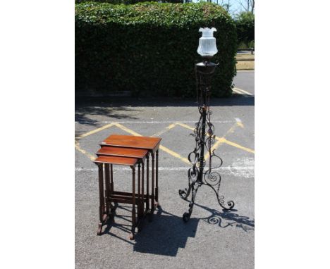 A VICTORIAN BLCK PAINTED ADJUSTABLE WROUGHT IRON LAMP STANDARD with tripod base together with a nest of three mahogany occasi