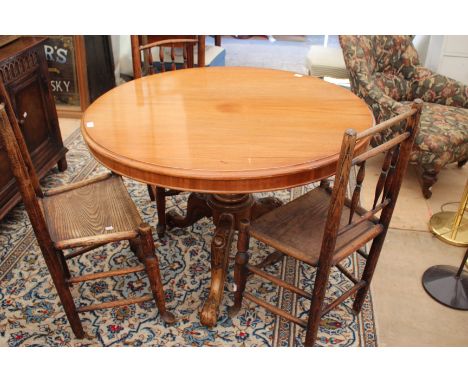 A CIRCULAR MAHOGANY BREAKFAST TABLE the tilt top on carved tripod base, approximately 106cm diameter 
