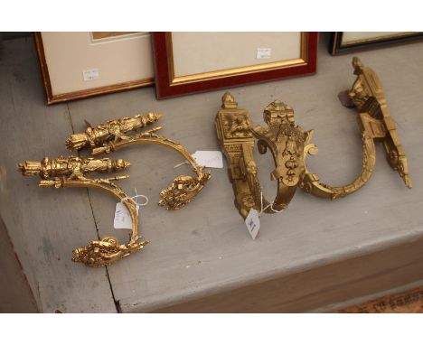 A PAIR OF CAST BRASS CURTAIN TIE BACK BRACKETS with acanthus leaf decoration 25cm high together with a further pair of curtai
