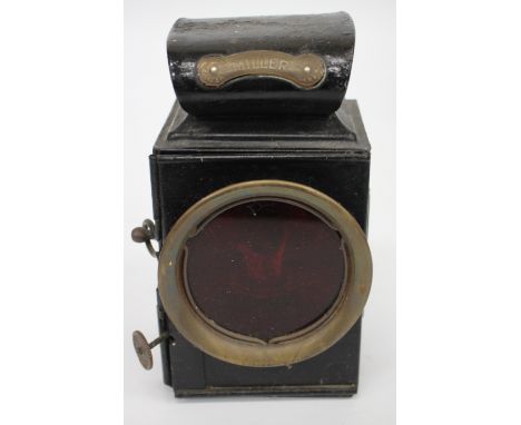 AN OLD BLACK PAINTED MILLER VEHICLE LAMP 17.5cm high