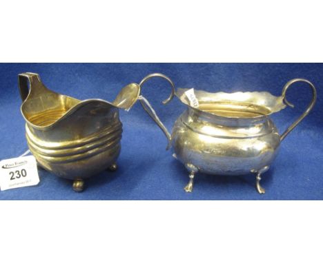 Silver ribbed design cream jug raised on four ball feet, together with silver twin handled sucrier. (2)   CONDITION REPORT:  