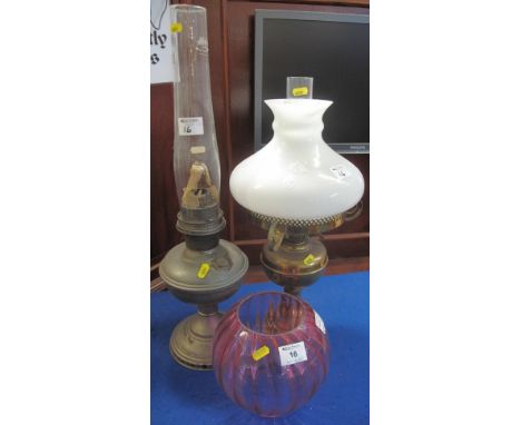 Brass double burner oil lamp with brass reservoir and base, opaque shade and clear chimney, together with another fluted, cra