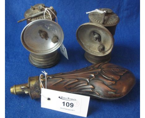 Pair of brass carbide bicycle lamps, early 1900s, together with a repousse brass shot flask with adjustable dispenser (broken