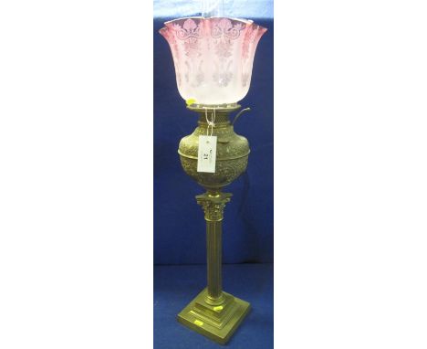 Brass Corinthian column oil lamp with repousse brass reservoir, cranberry etched frosted shade and clear chimney.   CONDITION