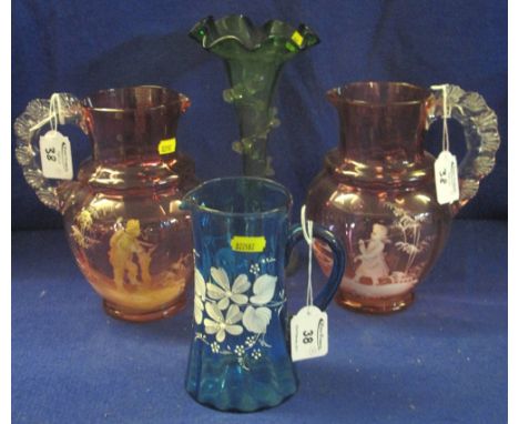 Two very similar Mary Gregory cranberry glass, baluster shaped jugs with clear shell moulded handles, both decorated with fig