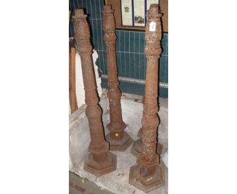 Set of four cast iron garden standard lamp bases or pillars. (4)