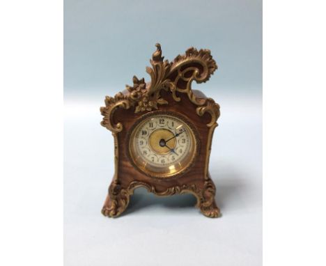 A small ornate walnut cased carriage clock, 14cm height