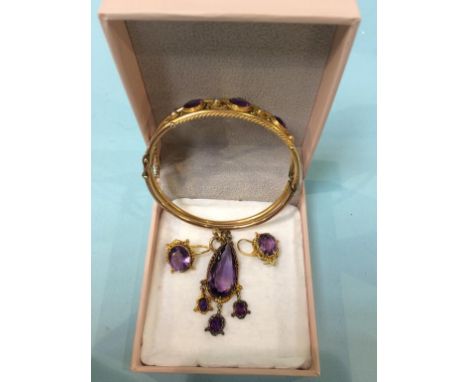 A 9ct gold bangle, mounted with amethysts and seed pearls, 12g and a pair of similar earrings and pendant