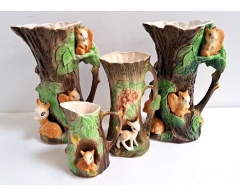 FOUR PIECES OF HORNSEA POTTERYall of tree trunk form with applied deer and squirrels, comprising four graduated jugs, two 28.