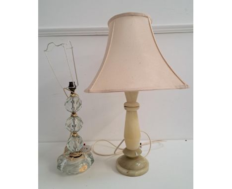 TWO TABLE LAMPSone carved geometric onyx lamp with a cream shade, approximately 64cm high; and a carved globular crystal lamp