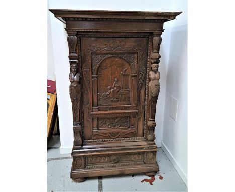 19th CENTURY FLEMISH CARVED OAK HALL CUPBOARDwith a carved panel door depicting a mother and child above a floral panel, flan