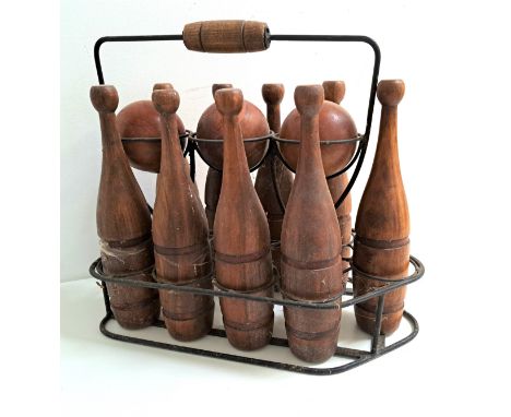 VINTAGE TEAK BOWLING SETcomprising three balls and nine shaped skittles, contained in a metal frame work carryall 