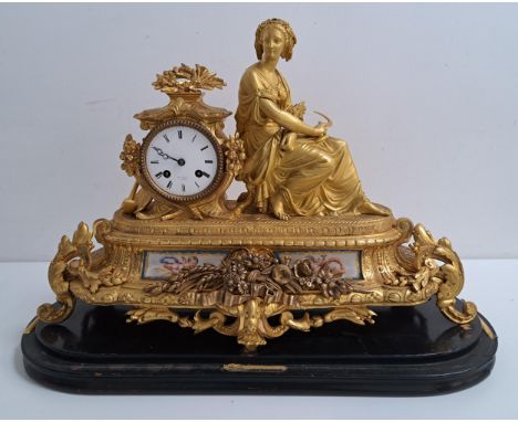 19th CENTURY FRENCH GILT METAL MANTLE CLOCKwith a circular enamel dial marked Hry Marc A Paris, with Roman numerals and an ei