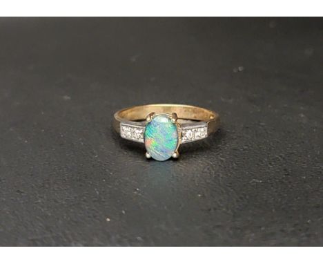 OPAL TRIPLET AND DIAMOND DRESS RING the central oval cabochon opal triplet measuring approximately 7.8mm x 5.9mm, flanked by 