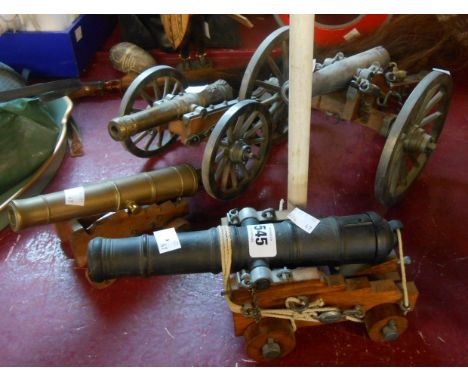 Four metal and wood scale model cannons