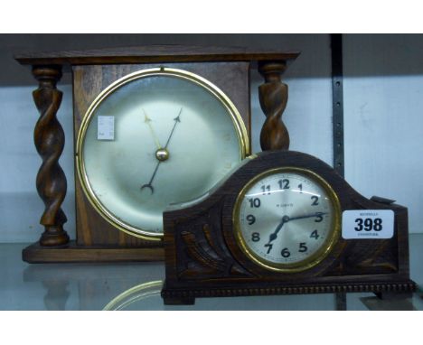 A small carved oak eight day timepiece - sold with an aneroid wall barometer with faded dial